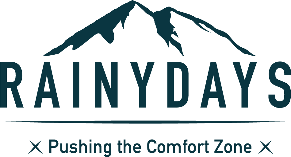 brand logo with mountains and slogan pushing the comfort zone