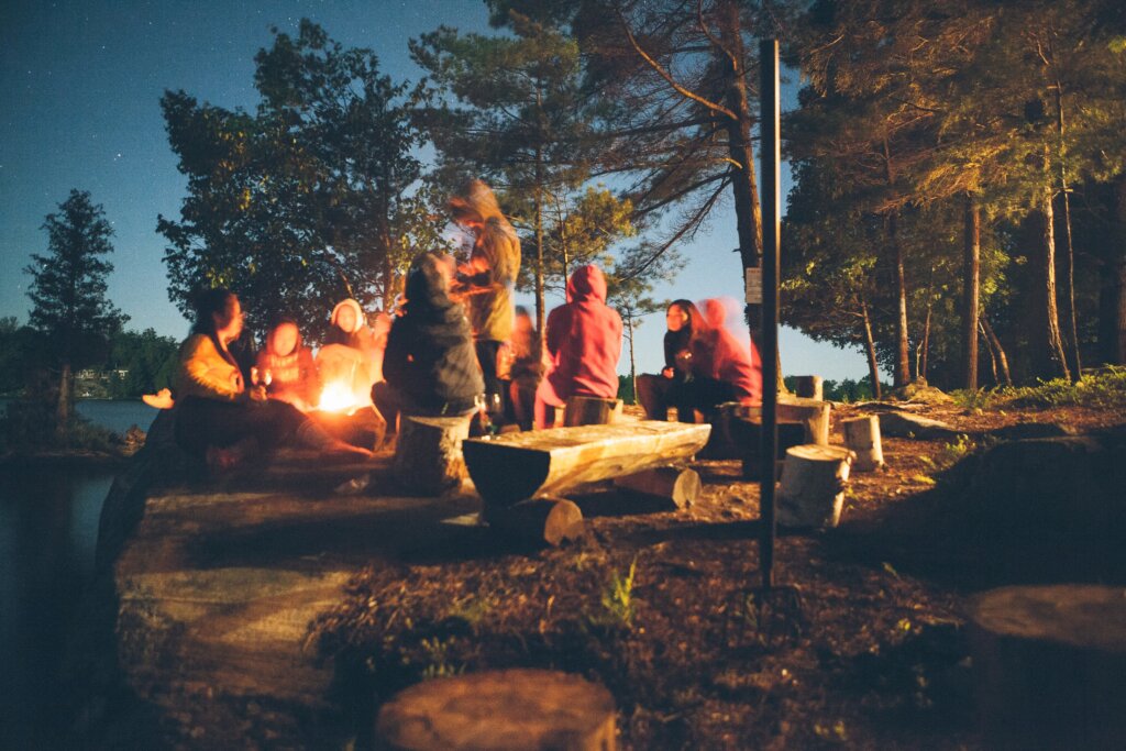 people sitting by the fire at night